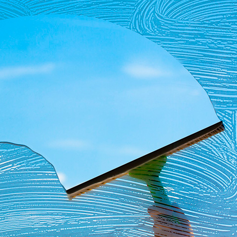 Illustration of a squeegee cleaning a bright blue window, representing E3’s window cleaning service.